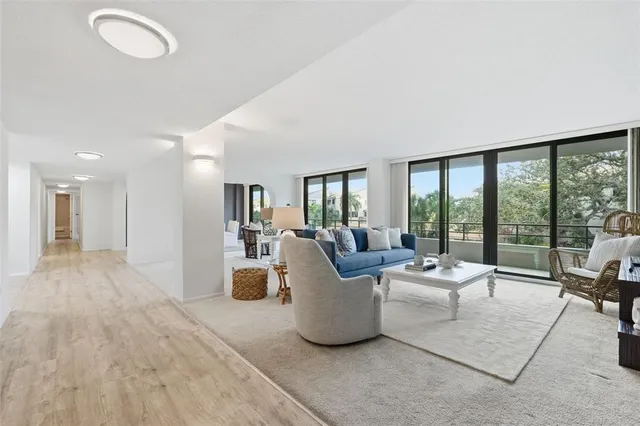 a living room with furniture and large windows