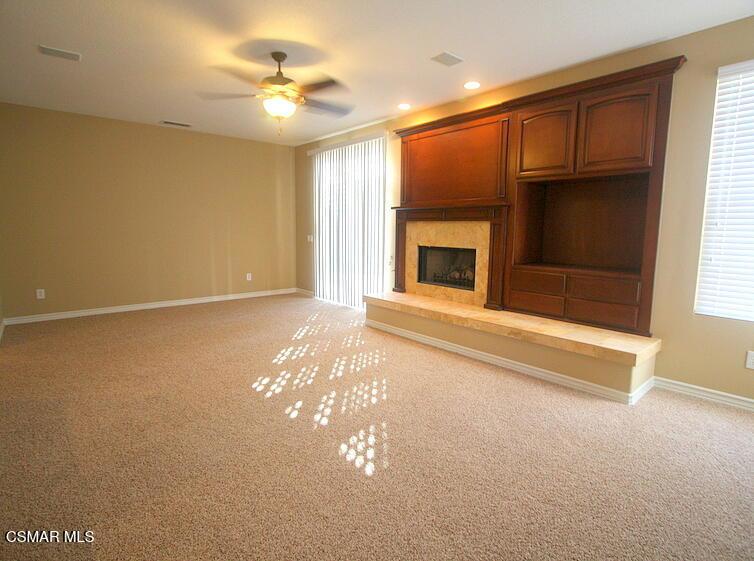 276 Chantilly Circle Simi Valley, CA 93065 - Photo 5 of 25 a view of livingroom with fireplace fan and window