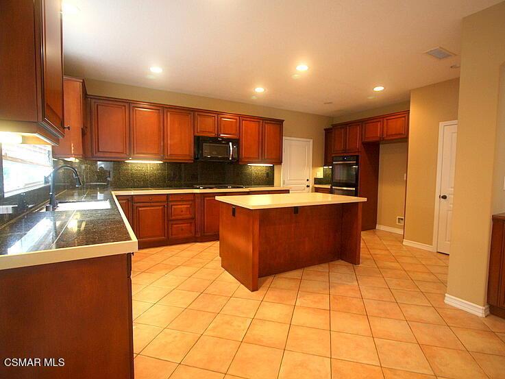 276 Chantilly Circle Simi Valley, CA 93065 - Photo 6 of 25 a kitchen with stainless steel appliances granite countertop a sink counter space cabinets and a large window