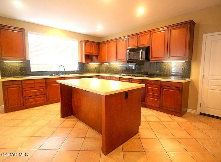 276 Chantilly Circle Simi Valley, CA 93065 - Photo 7 of 25 a kitchen with stainless steel appliances granite countertop a stove sink and cabinets