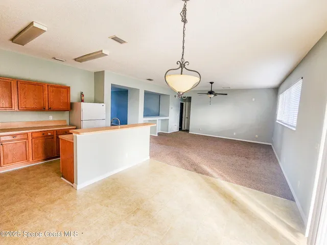 a view of a kitchen with a sink cabinets and wooden floor