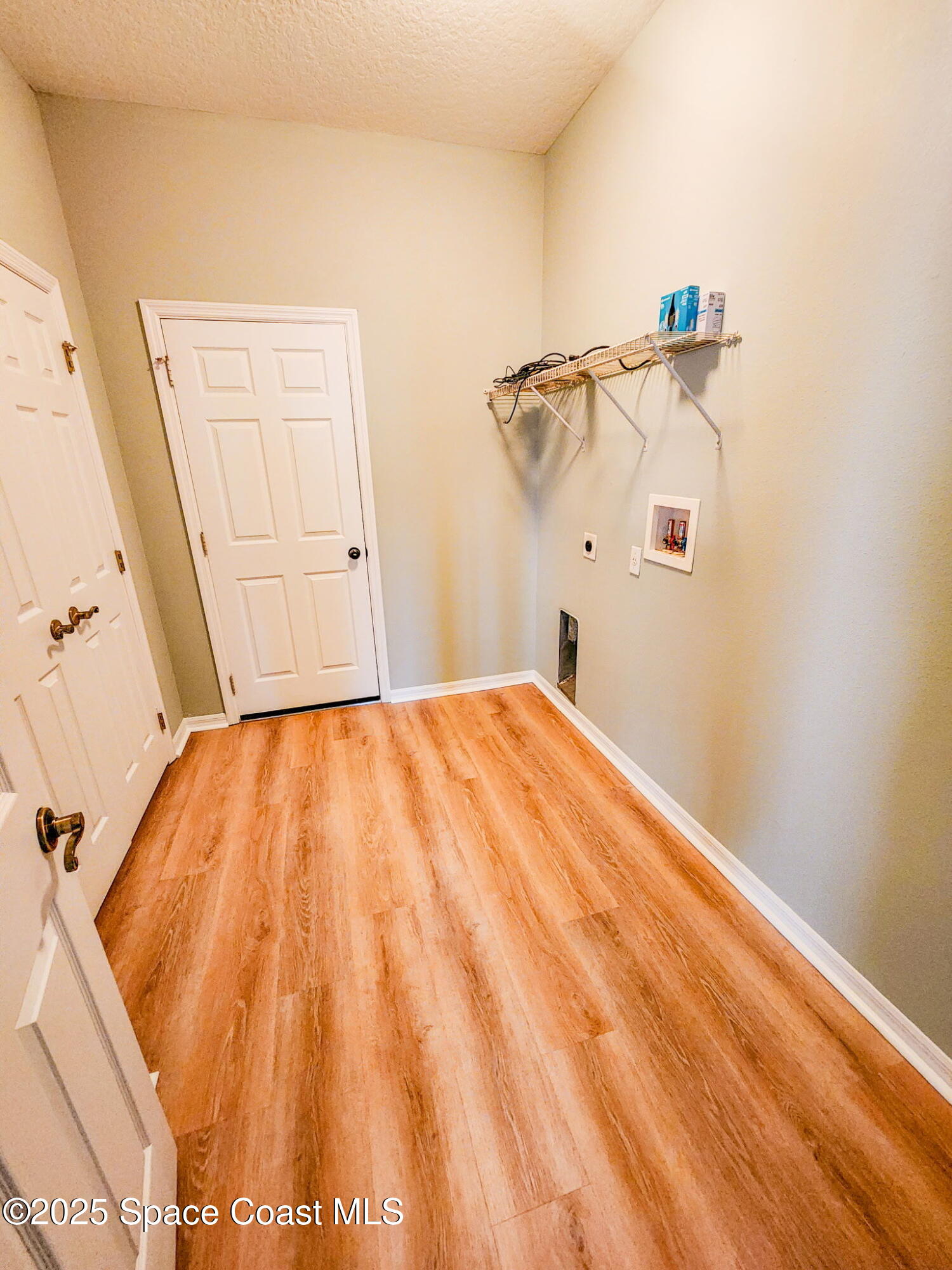 1421 Halstead Avenue Northwest Palm Bay, FL 32907 - Photo 14 of 22 a bedroom with a bed and a wooden floor