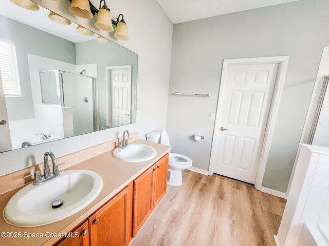 a bathroom with 2 sink and a mirror