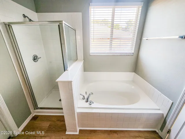 a bathroom with a tub and a shower