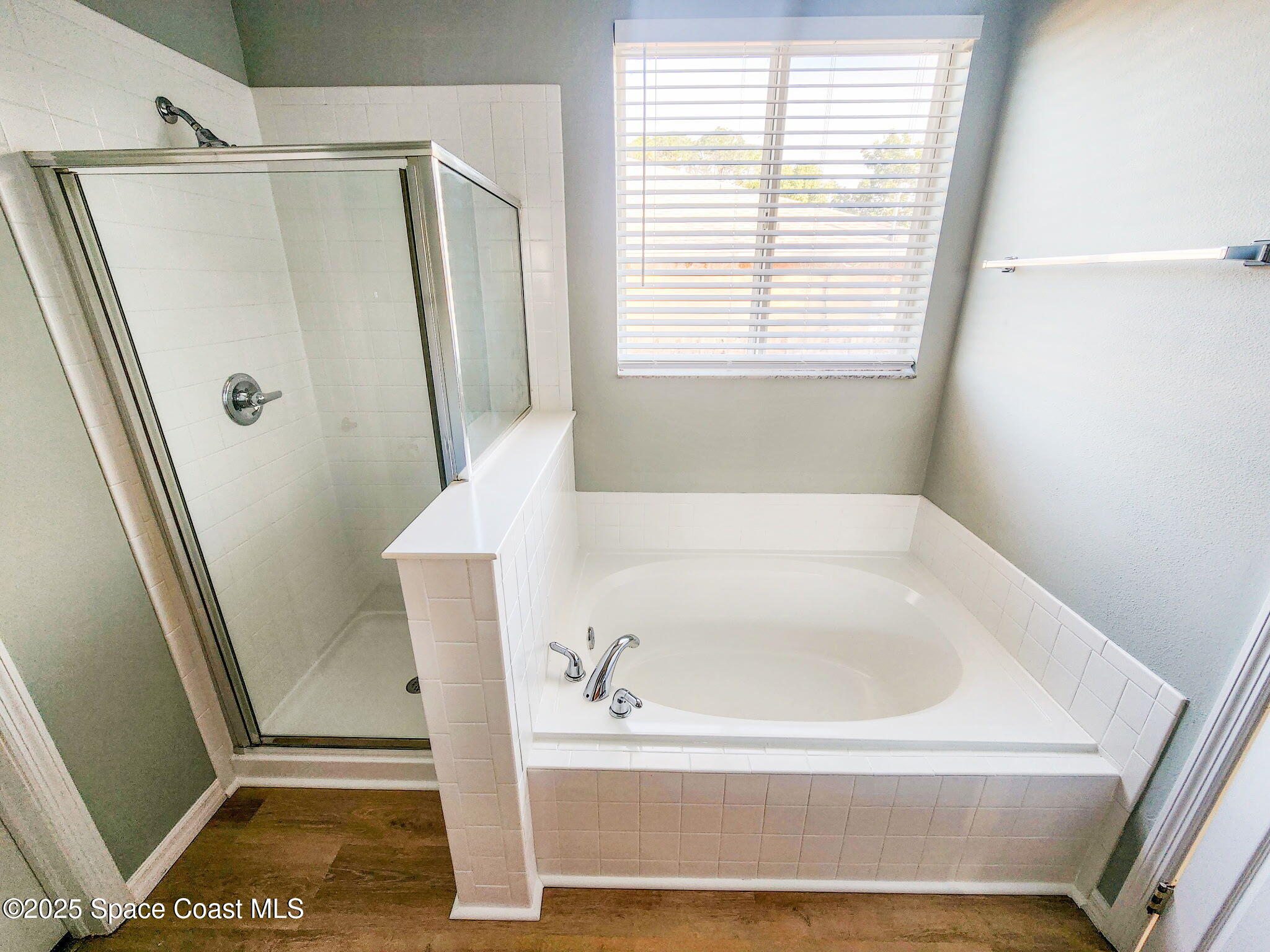 1421 Halstead Avenue Northwest Palm Bay, FL 32907 - Photo 18 of 22 a bathroom with a tub and a shower