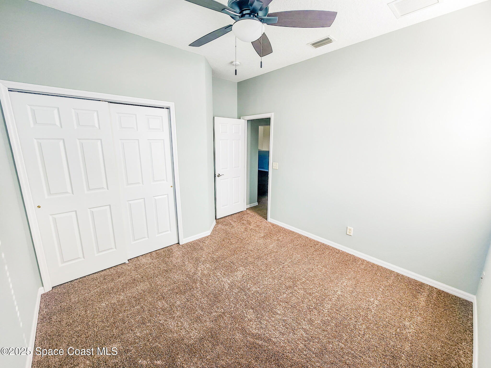 1421 Halstead Avenue Northwest Palm Bay, FL 32907 - Photo 21 of 22 an empty room with a ceiling fan and a window