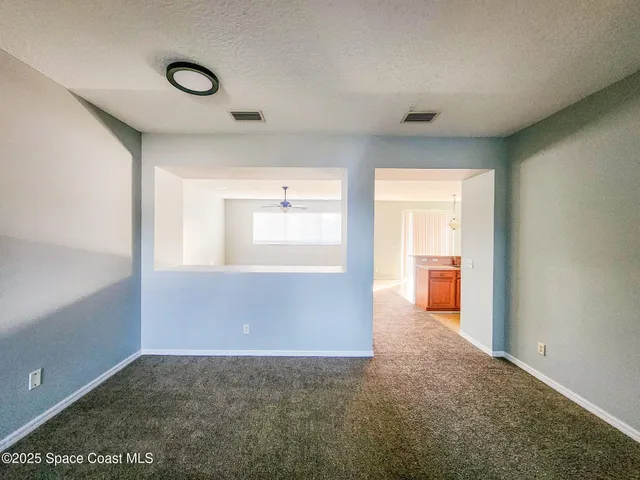 a view of an empty room and a window