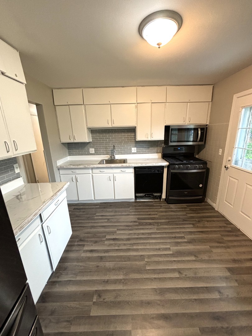 50 Marnel Road Montgomery, IL 60538 - Photo 3 of 12 a view of a kitchen with wooden floor and electronic appliances