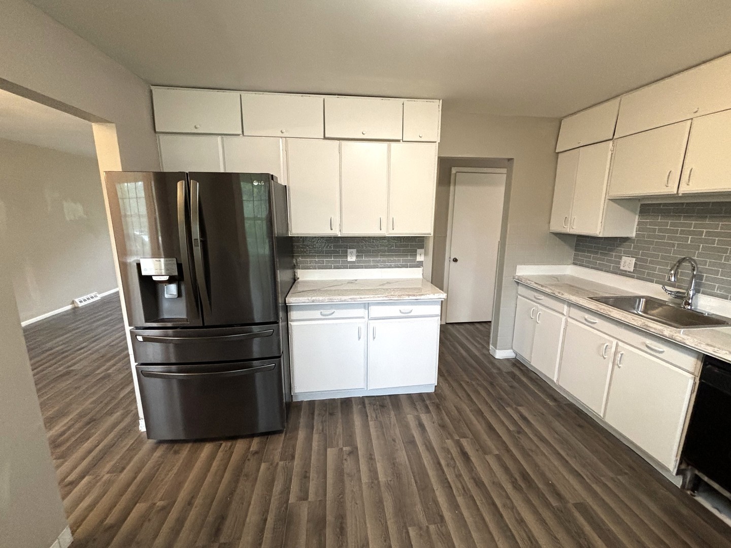 50 Marnel Road Montgomery, IL 60538 - Photo 4 of 12 a kitchen with a refrigerator wooden floor and white cabinets