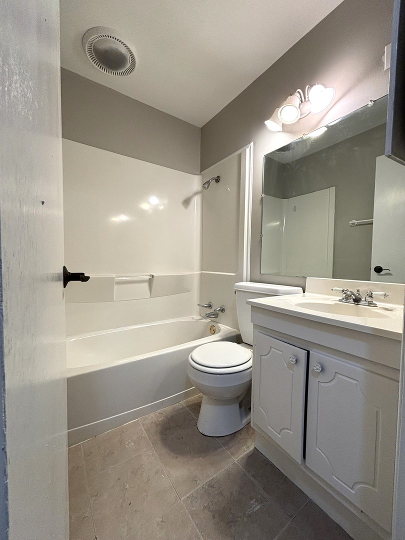 50 Marnel Road Montgomery, IL 60538 - Photo 6 of 12 a bathroom with a toilet a sink a tub and a mirror