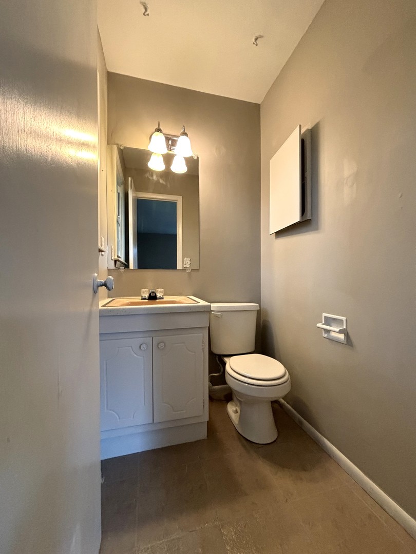 50 Marnel Road Montgomery, IL 60538 - Photo 8 of 12 a bathroom with a toilet sink and mirror