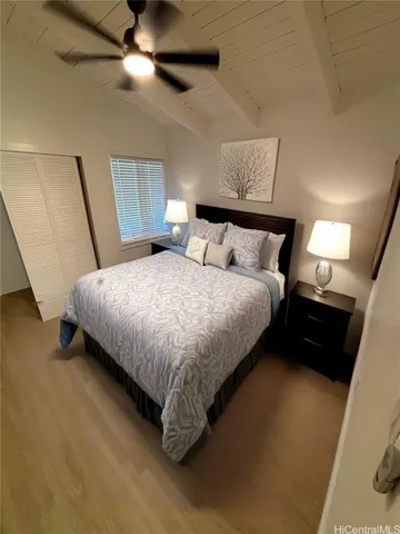 a bedroom with bed and a chandelier