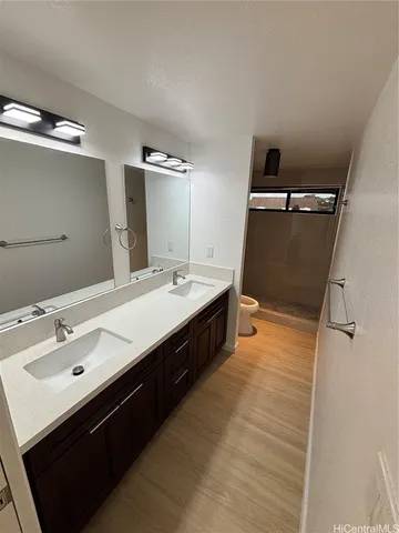 a spacious bathroom with a double vanity sink and mirror