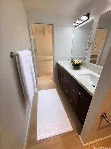 a bathroom with a sink a mirror and vanity