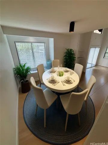 a dining room with furniture and wooden floor