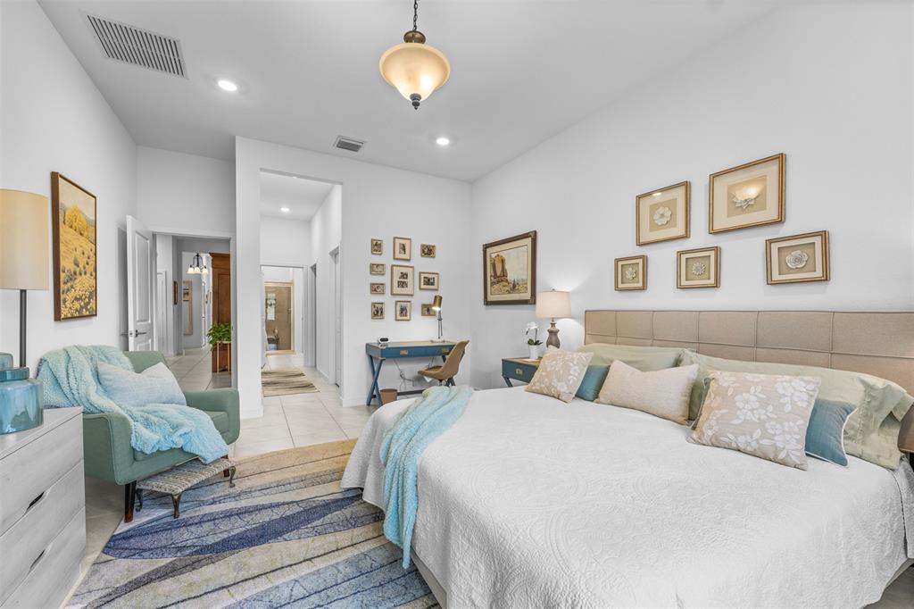 19707 Weathervane Way Loxahatchee, FL 33470 - Photo 16 of 51 a spacious bedroom with a bed and glass walk in closet