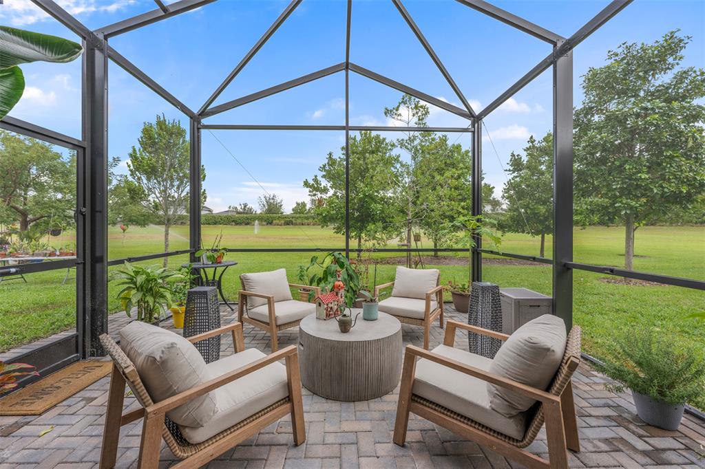 19707 Weathervane Way Loxahatchee, FL 33470 - Photo 2 of 51 a balcony with furniture and umbrella