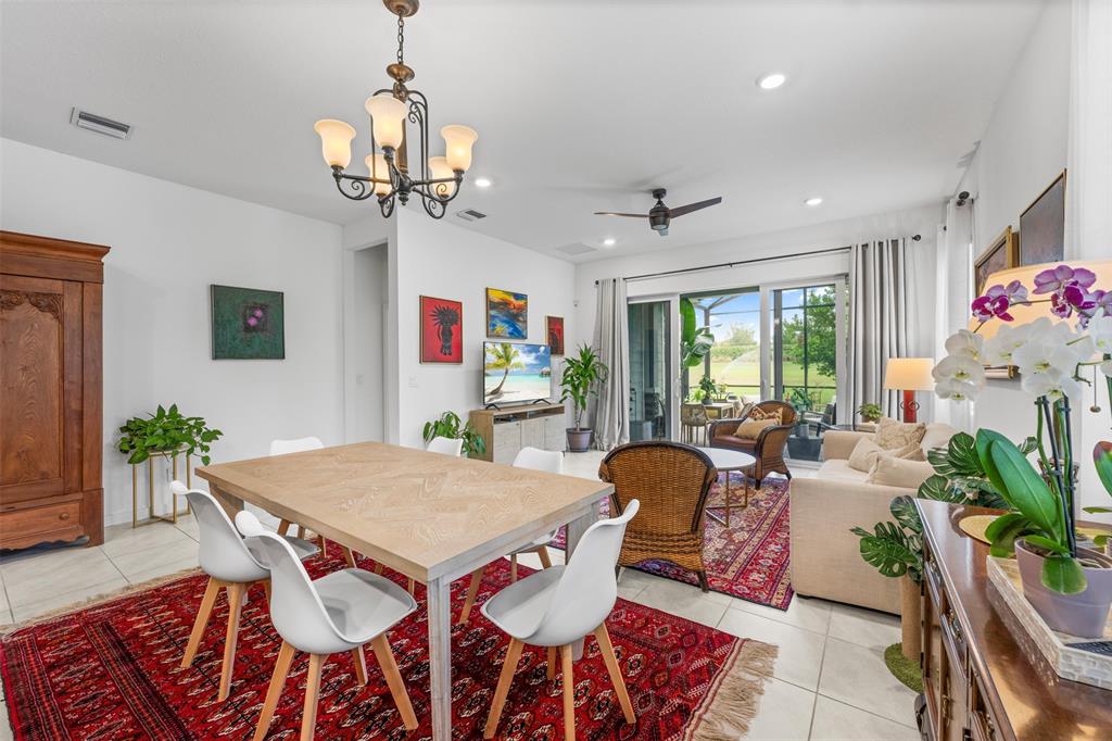 19707 Weathervane Way Loxahatchee, FL 33470 - Photo 21 of 51 a view of a dining room with furniture and a chandelier