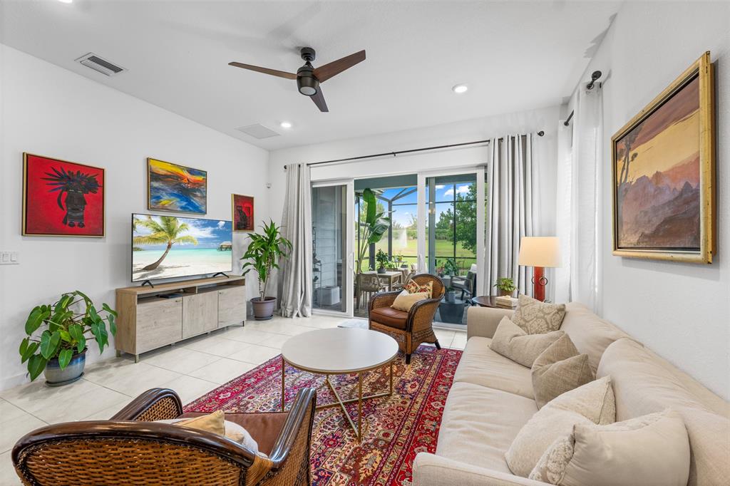 19707 Weathervane Way Loxahatchee, FL 33470 - Photo 23 of 51 a living room with furniture a rug and a flat screen tv