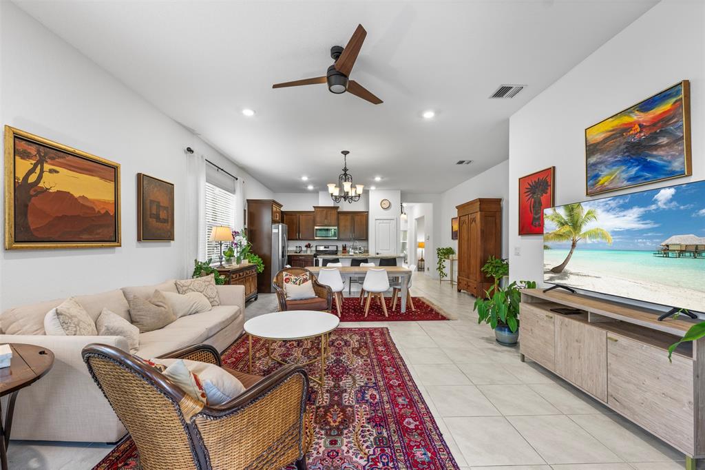 19707 Weathervane Way Loxahatchee, FL 33470 - Photo 24 of 51 a living room with fireplace furniture and a flat screen tv