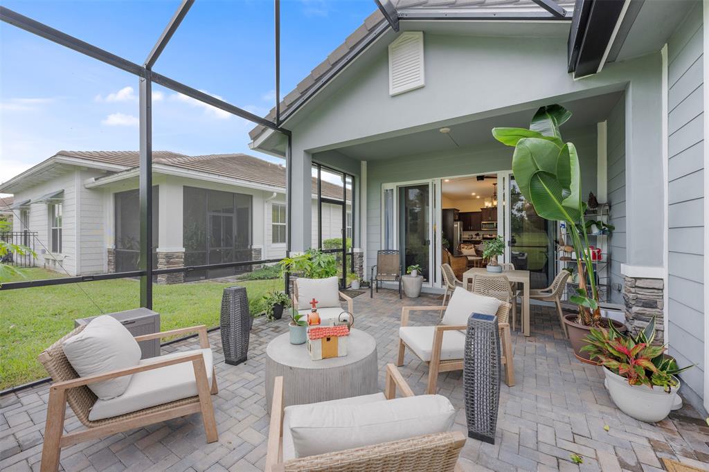 19707 Weathervane Way Loxahatchee, FL 33470 - Photo 27 of 51 a living room filled with furniture and a garden