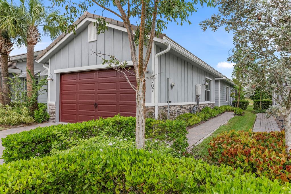 19707 Weathervane Way Loxahatchee, FL 33470 - Photo 30 of 51 a view of a house with a small yard plants and large tree