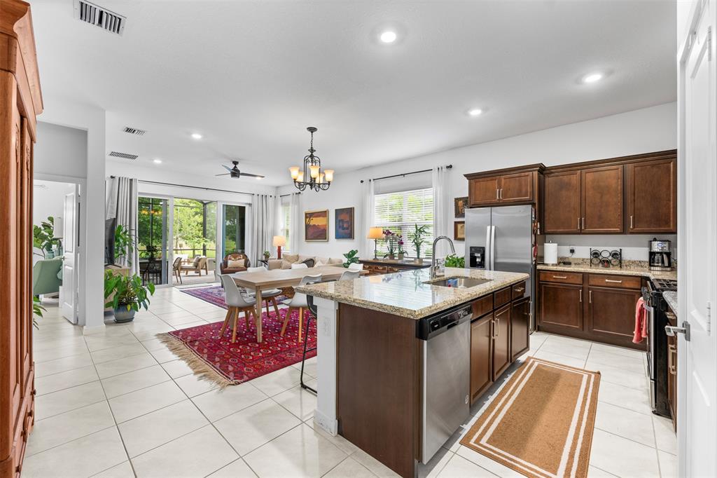 19707 Weathervane Way Loxahatchee, FL 33470 - Photo 3 of 51 a kitchen with stainless steel appliances granite countertop a stove top oven a sink dishwasher and a refrigerator with the cabinets