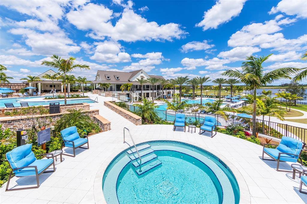 19707 Weathervane Way Loxahatchee, FL 33470 - Photo 49 of 51 a swimming pool with outdoor seating and city view