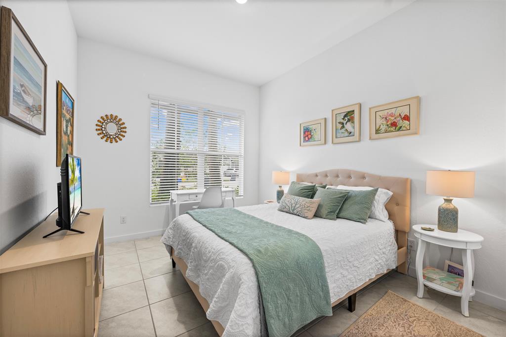 19707 Weathervane Way Loxahatchee, FL 33470 - Photo 9 of 51 a bedroom with a bed and a flat screen tv