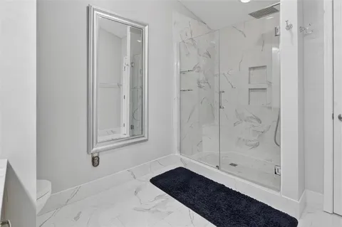 a bedroom with a bed gym equipment and a window