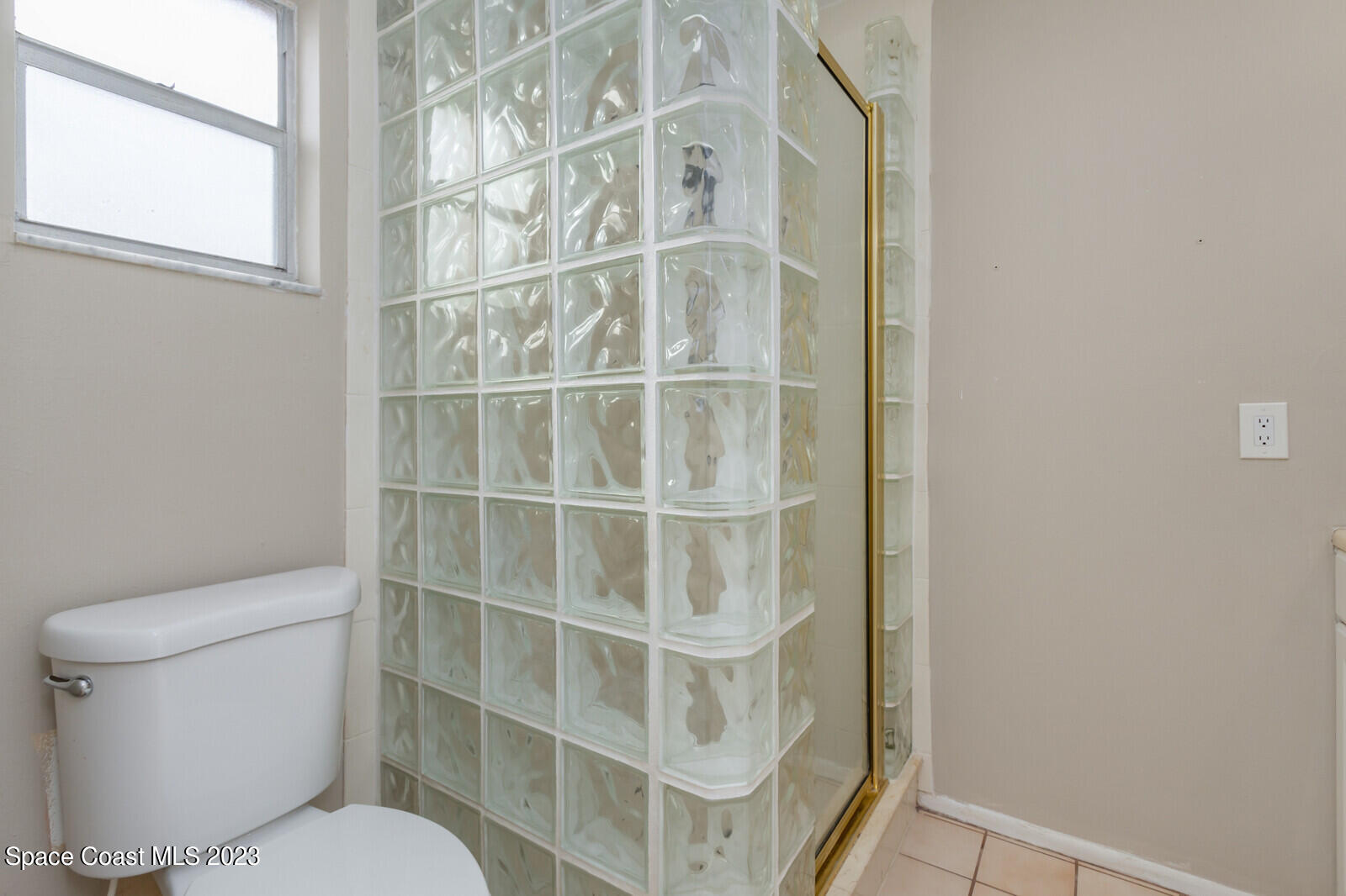3229 Marshall Drive Melbourne, FL 32901 - Photo 18 of 36 a bathroom with a toilet and a window