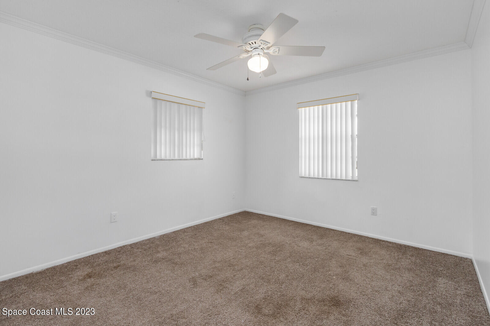 3229 Marshall Drive Melbourne, FL 32901 - Photo 21 of 36 an empty room with windows and ceiling fan