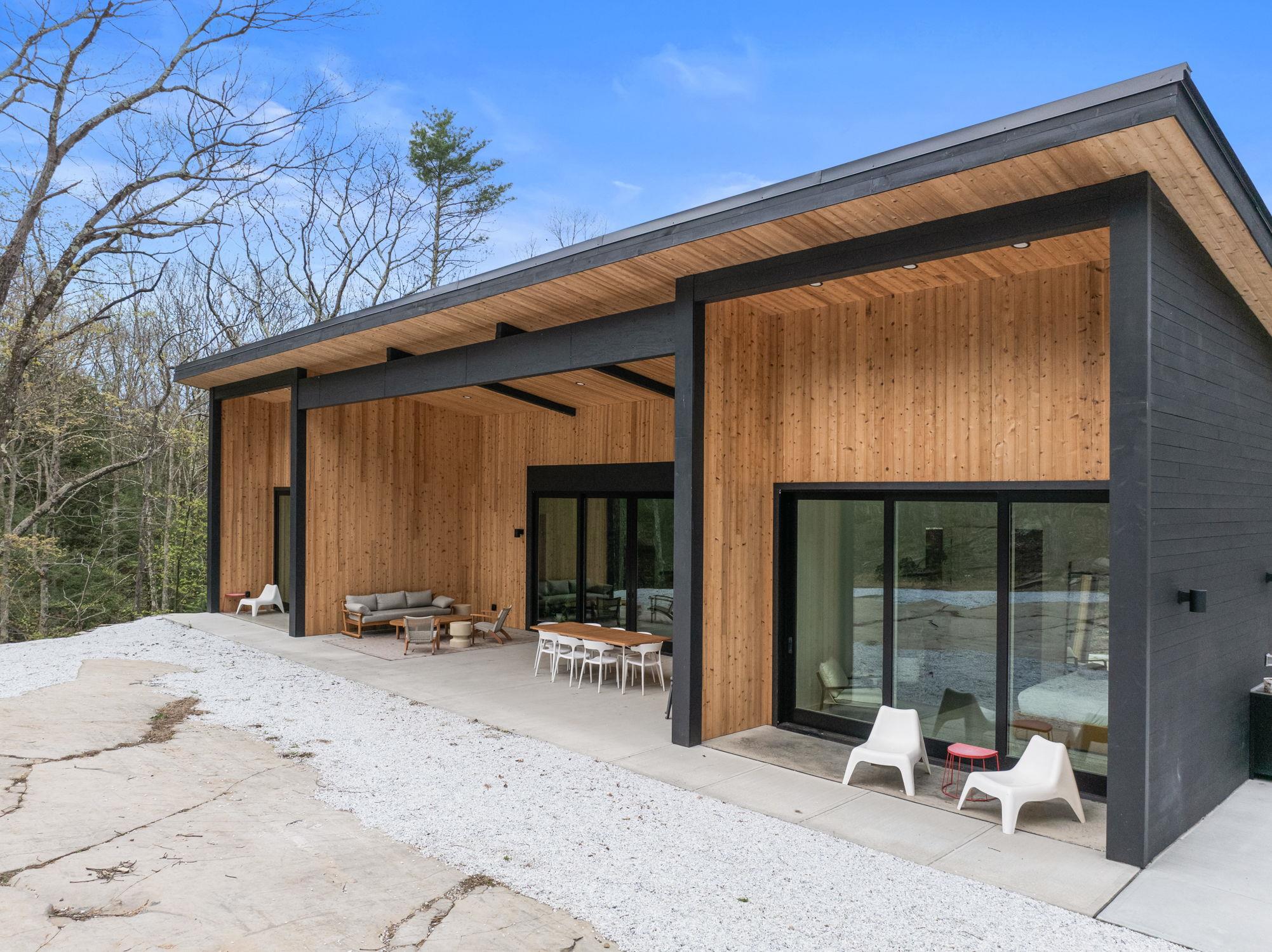 Rear view of property with an outdoor living space and a patio