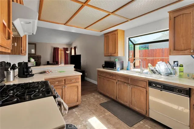 a kitchen with stainless steel appliances a sink stove and cabinets