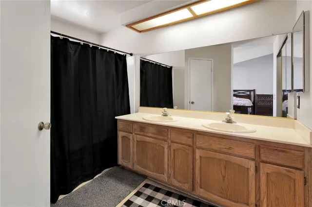 a bathroom with a double vanity sink and mirror