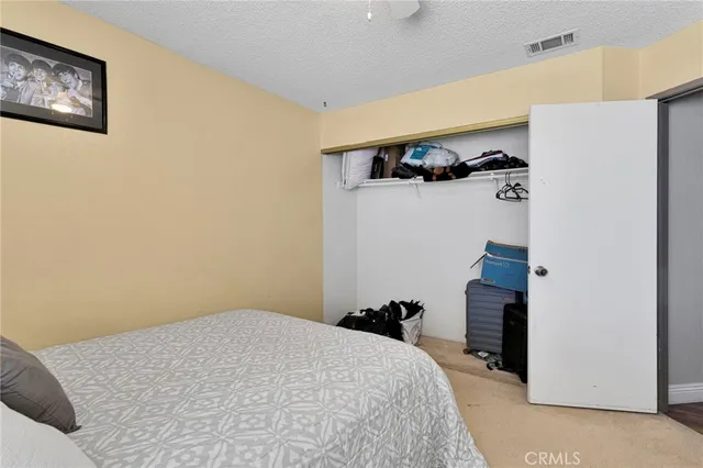 a bedroom with a bed and cabinets