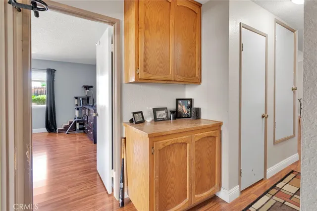 a view of a hallway with wooden floor and closet