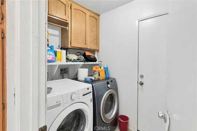 a view of storage and utility room with washer and dryer
