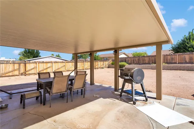 a view of a dining room with a table and chairs