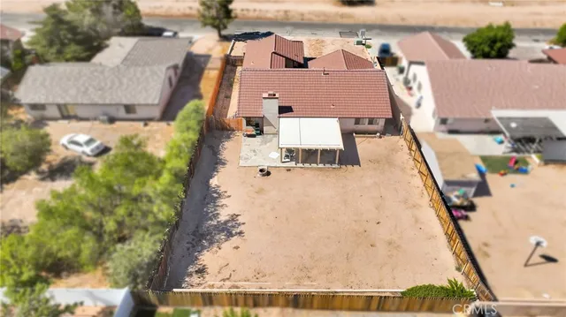 an aerial view of a house with a yard