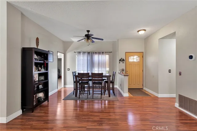 a view of a a dining room with furniture window and wooden floor