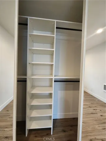 a view of walk in closet with empty racks