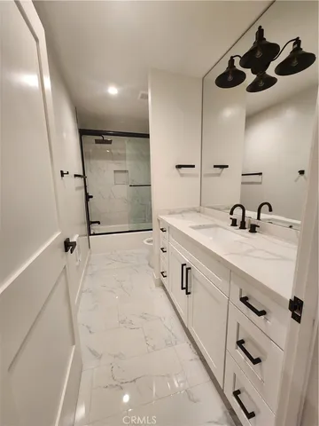 a bathroom with a glass shower door