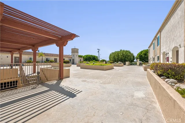a view of a room with wooden floor and cabinets