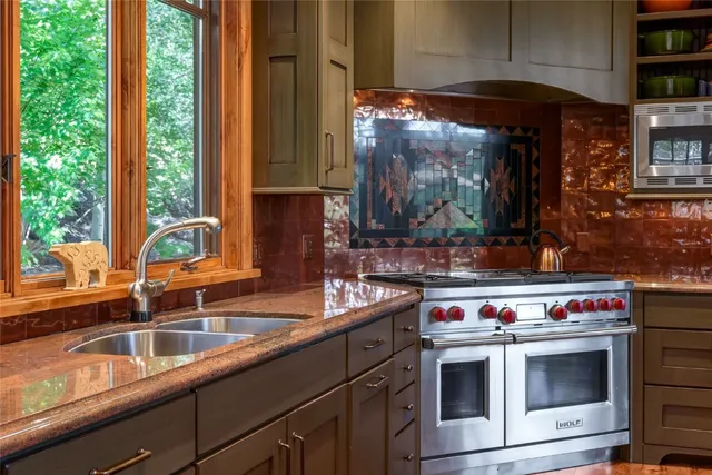 a kitchen filled a counter top space and a window