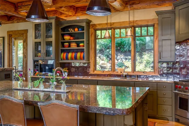 a kitchen with a refrigerator and wooden cabinets