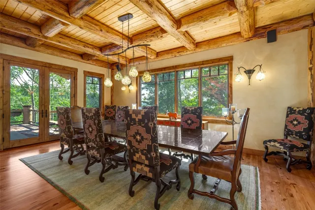 a patio with water view fountain with wooden floor and outdoor space