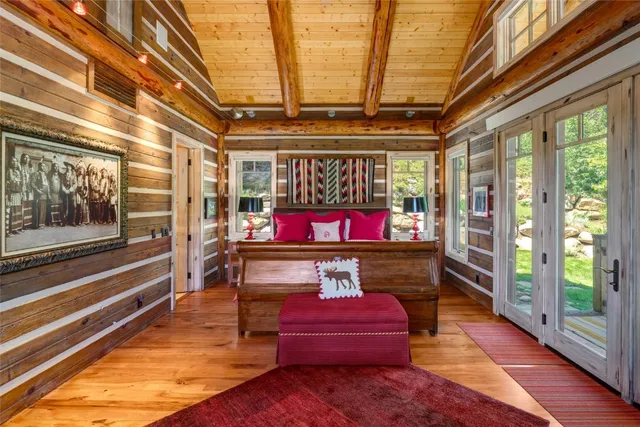 a view of a gym with wooden floor and furniture