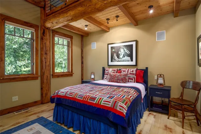 a bedroom with bed and a large window