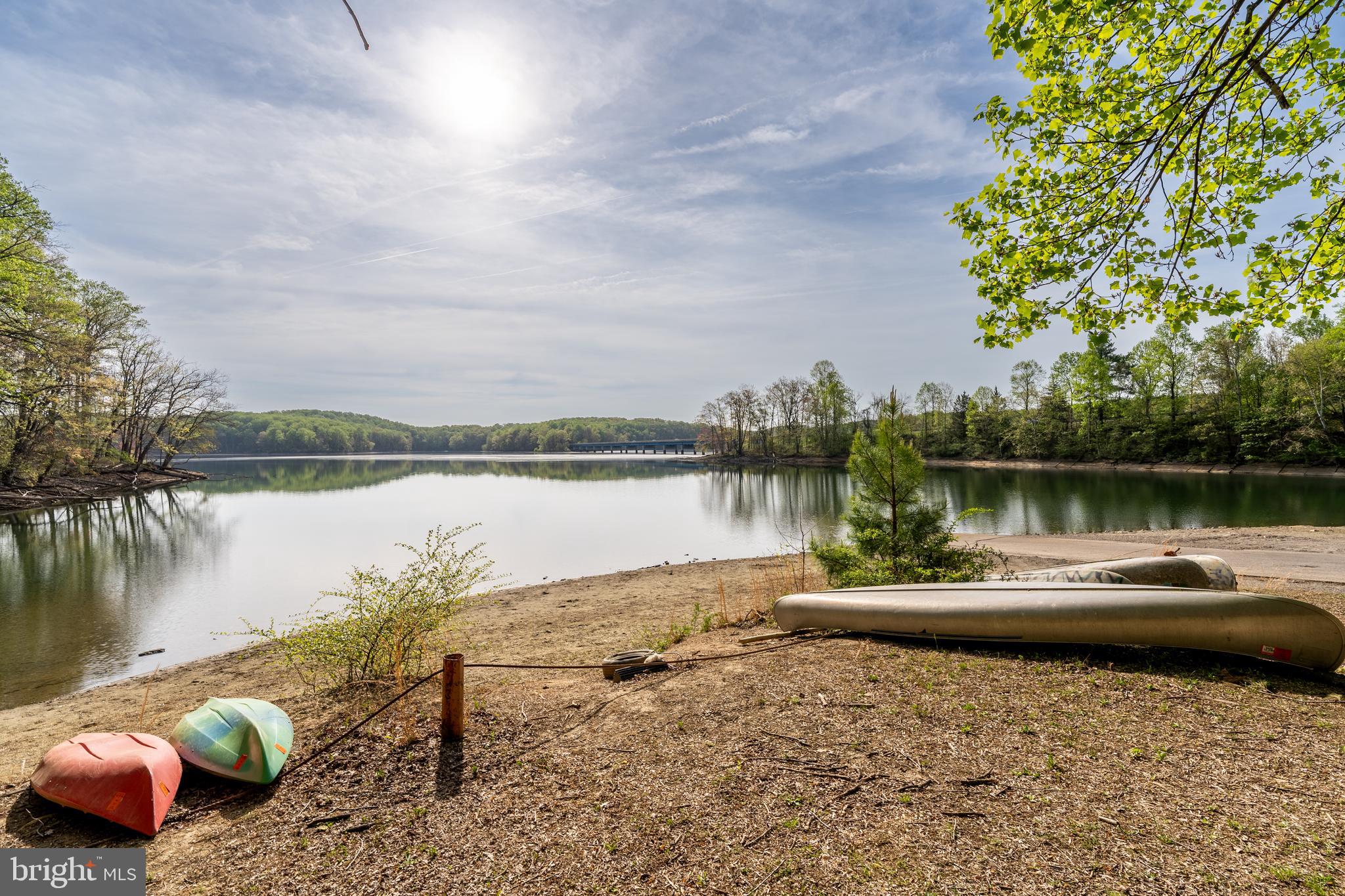 1346 Becket Road Eldersburg, MD 21784 - Photo 68 of 73 a view of a lake with lawn chairs and wooden fence